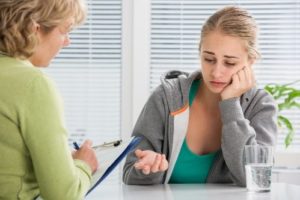 Medical Professional helping stressed teen